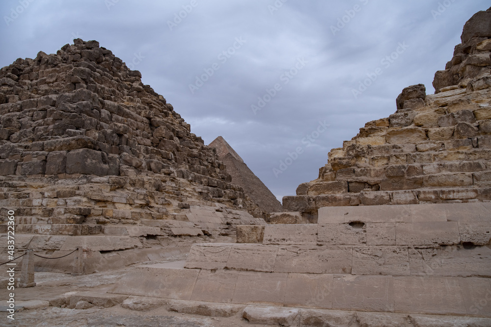 Ruins of the small pyramid of Queen Henutsen with Khafre Pyramids at background, Giza Plateau, Egypt. UNESCO World Heritage Ruins of the small pyramid of Queen Henutsen with Khafre Pyramids at background, Giza Plateau, Egypt. UNESCO World Heritage
