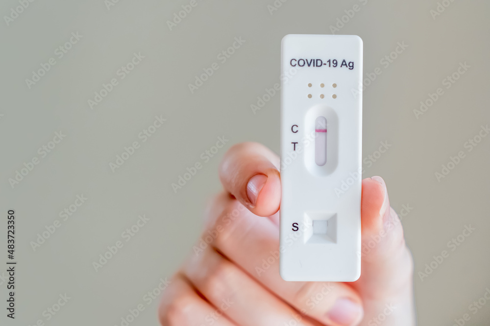 Hands holding Covid-19 rapid antigen test cassette with negative result of rapid diagnostic test Hands holding Covid-19 rapid antigen test cassette with negative result of rapid diagnostic test