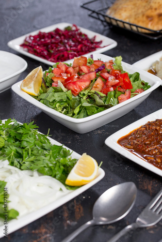 turkish kebab appetizers, salad, lavash,  on the dark bacground
