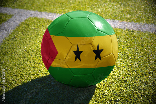 football ball with the national flag of sao tome and principe lies on the green field