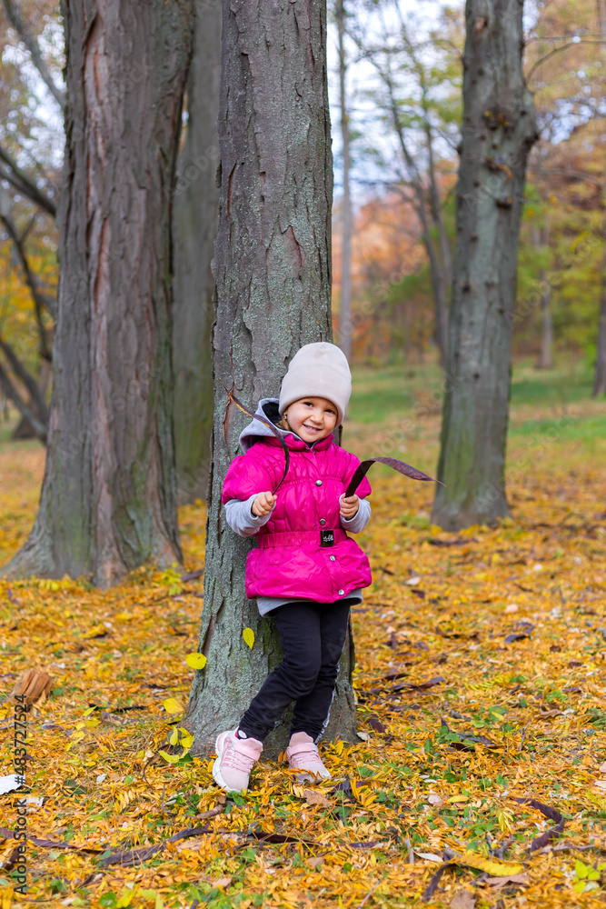 Happy little girl in the park. Autumn season. Happy little girl in the park. Autumn season.