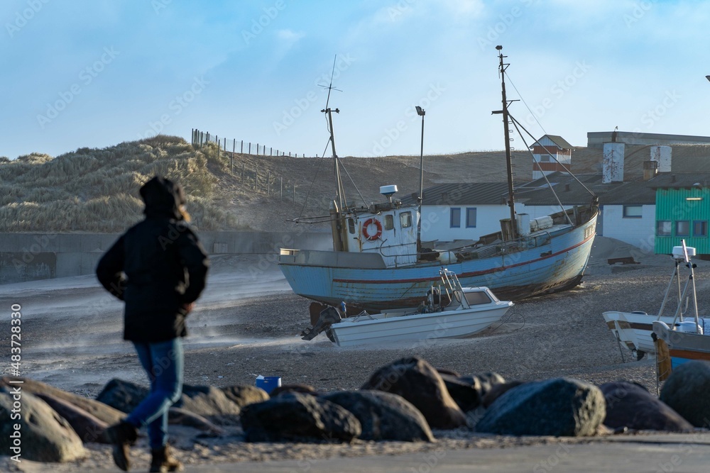 traditional fisher boats on the beach in northern Denmark in norre vorupor on a stormy day traditional fisher boats on the beach in northern Denmark in norre vorupor on a stormy day