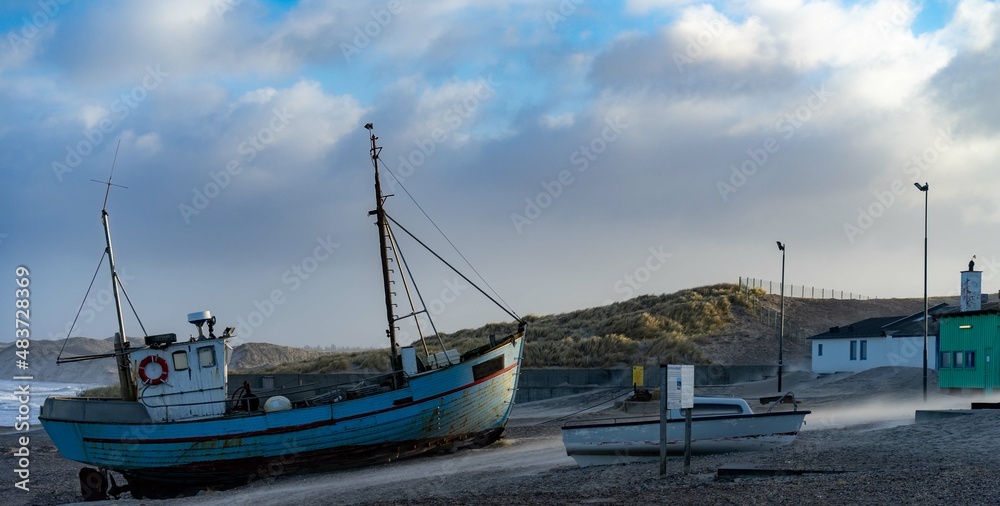 traditional fisher boats on the beach in northern Denmark in norre vorupor on a stormy day