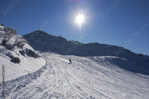 skier rushes down a snowy slope