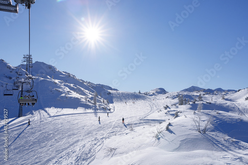 skiers rushes down a snowy slope