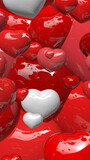 zomm on various sizes of red or white shinny hearts scattered in the air in portrait format