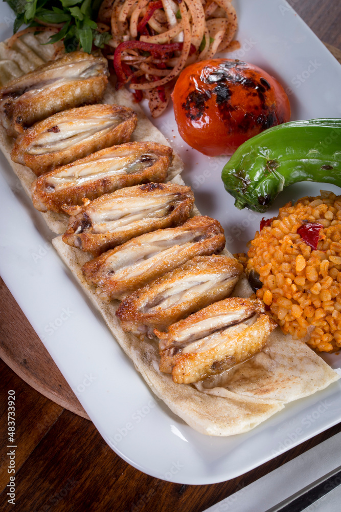 grilled wings with tomato pepper and bulgur pilaf