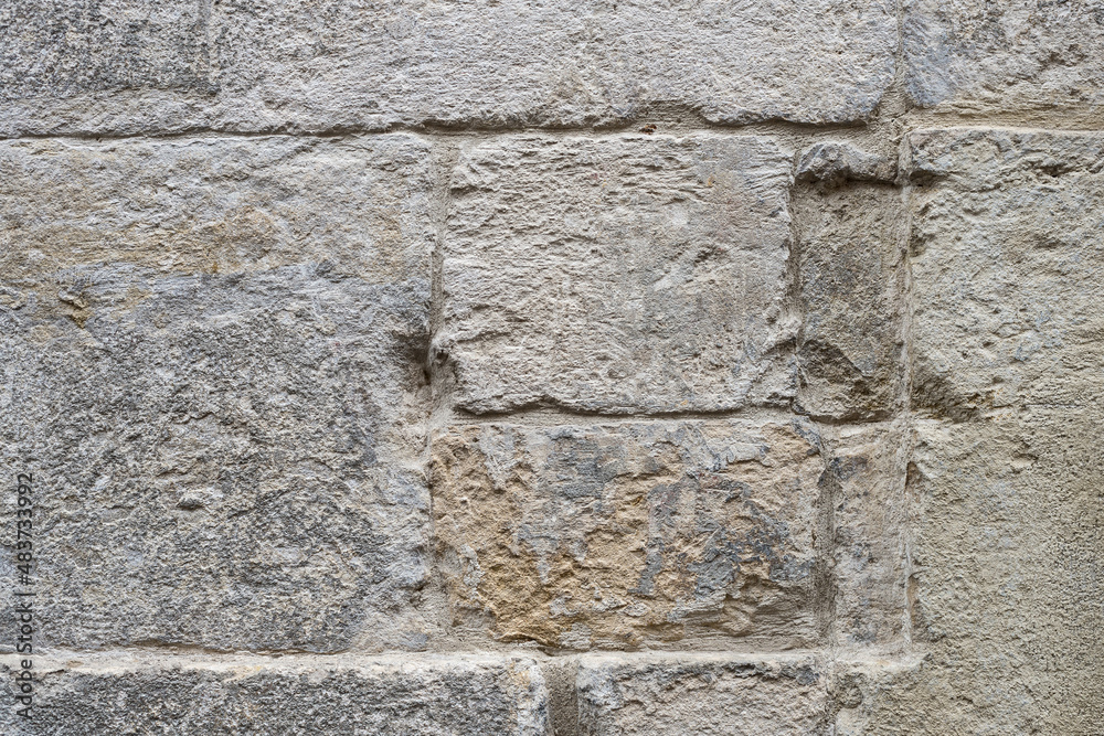 Ancient wall made of rectangular natural factured stones. Old dirty brick wall. Ancient wall made of rectangular natural factured stones. Old dirty brick wall.