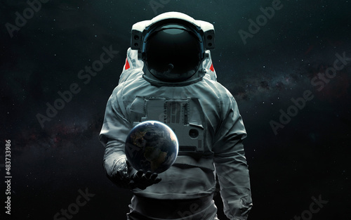 Fototapeta Naklejka Na Ścianę i Meble -  Astronaut holding Earth planet in hand. 3D sci-fi art. Elements of image provided by Nasa