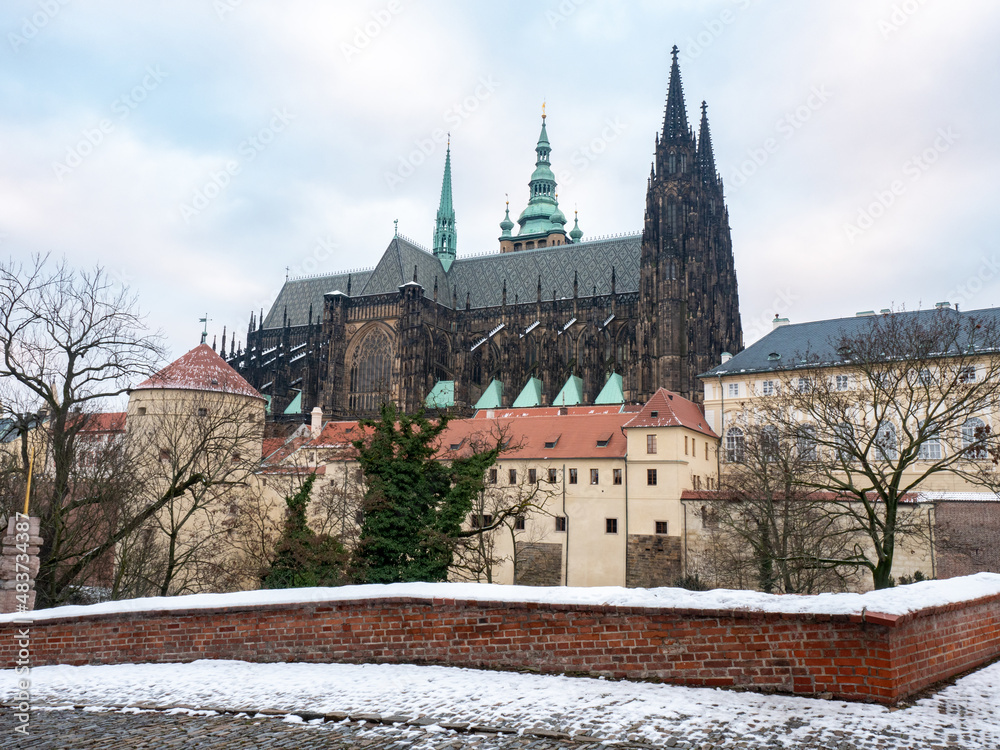 Snowy Prague City with gothic Castle and colorful Trees, Czech Republic