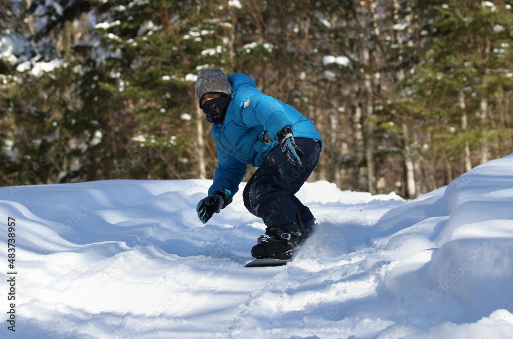 young child having fun with snowboard