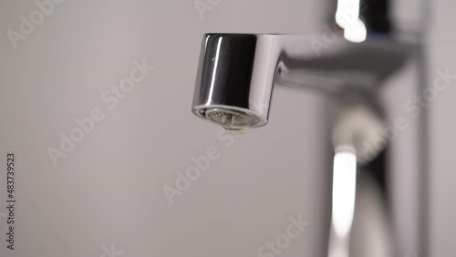 Mixer valve. Water drip drops from a water pipe. Closed faucet tap. Leak.