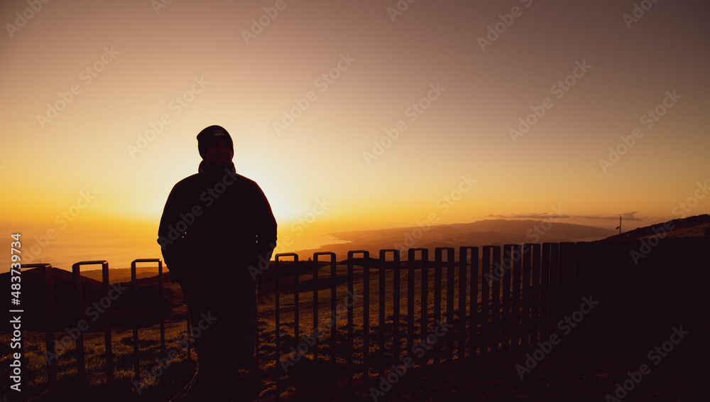 Silhouette of man, standing at viewpoint, sunset at island. Silhouette of man, standing at viewpoint, sunset at island.
