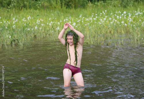 young boy having fun in water during summer