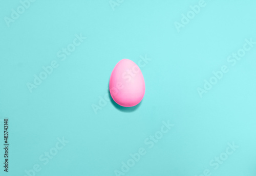 Easter eggs colored with pink color on a blue background. Flat lay. Copy space for text, mock up. Banner. 