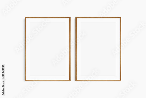 Frame mockup 5x7, 50x70, A4, A3, A2, A1. Set of two thin cherry wood frames. Gallery wall mockup, set of 2 frames. Clean, modern, minimalist, bright. Portrait. Vertical. Mat opening 2:3.