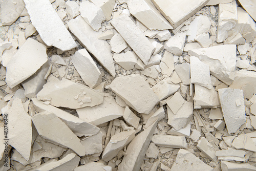 the surface is dotted with splinters and pieces of broken gypsum blocks
