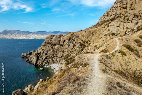 Aerial view of cliffed coast line cape Meganom Crimea Rocks line the shore of Black sea.