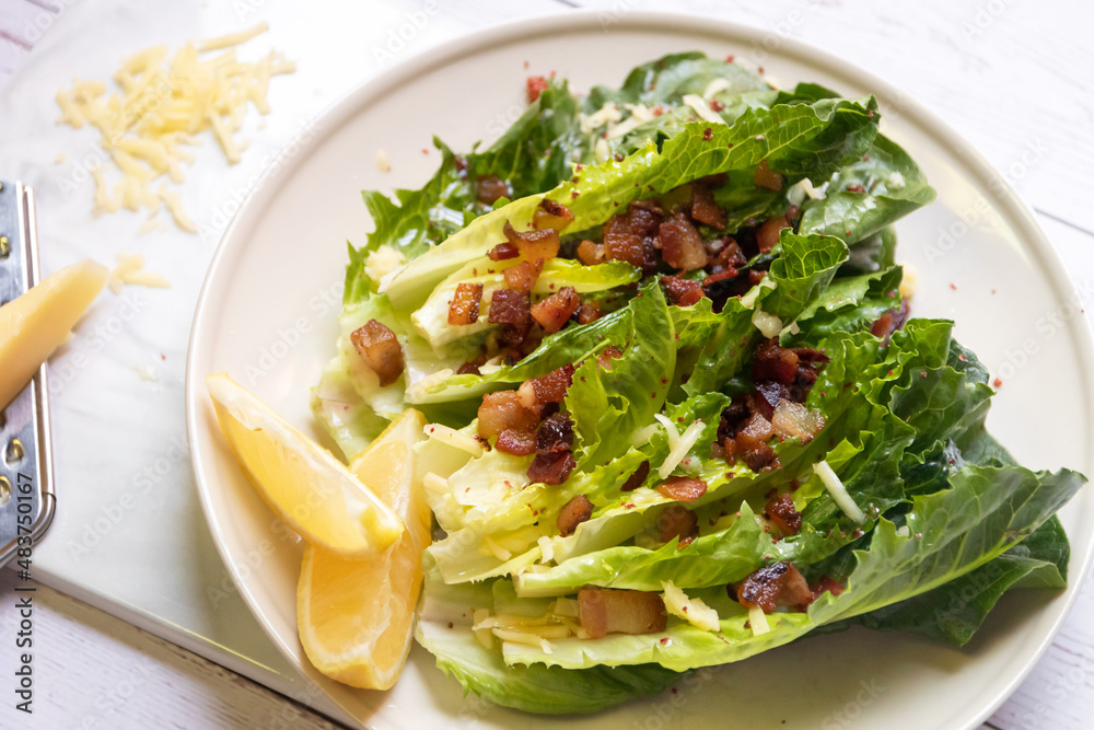 Cos lettuce salad with crispy bacon, and parmesan cheese. Easy healthy recipes. 