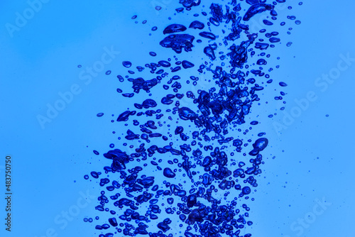 Clear water with air bubbles on blue background