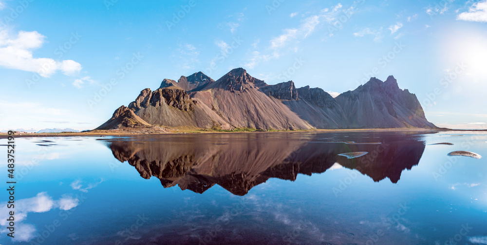 beautiful landscape with most breathtaking mountains Vestrahorn on the Stokksnes peninsula in the mirror of the lake. Exotic countries. Amazing places. (Meditation, antistress - concept).
