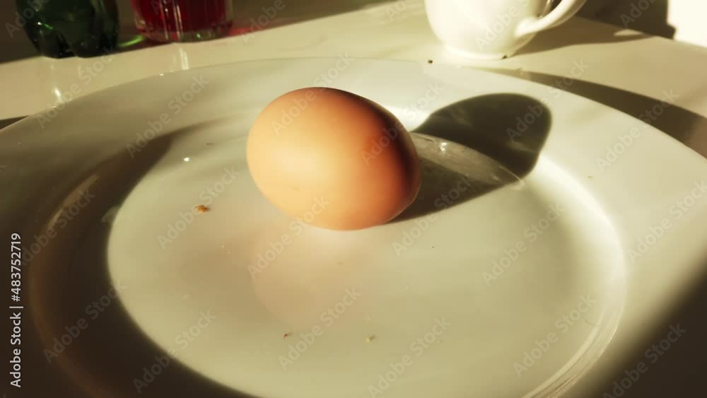 Person tapping hard boiled egg cracking shell for breakfast healthy eating