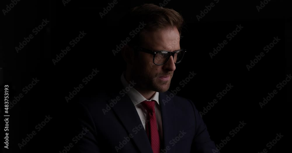 sexy businessman folding his arms, touching his face, looking away and smiling sexy businessman folding his arms, touching his face, looking away and smiling