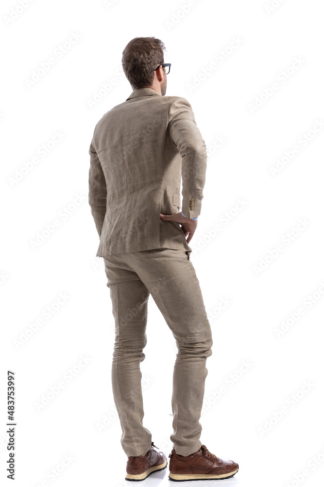 handsome businessman standing with one hand on his hip handsome businessman standing with one hand on his hip