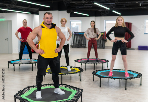 Women's and men's group on a sports trampoline, fitness training, healthy life - a concept trampoline group batut instructor healthy, from female team for sporty and exercise motion, smiling beautiful photo