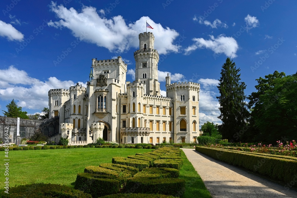 Beautiful old white castle with castle garden in summer sunny day with blue sky in the background. Concept for architecture, travel and tourism. Hluboka nad Vltavou - Czech Republic - Europe.