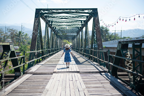 Woman traveller sightseeing on Pai Memorial bridge in Pai, Chiang Mai, Thailand.