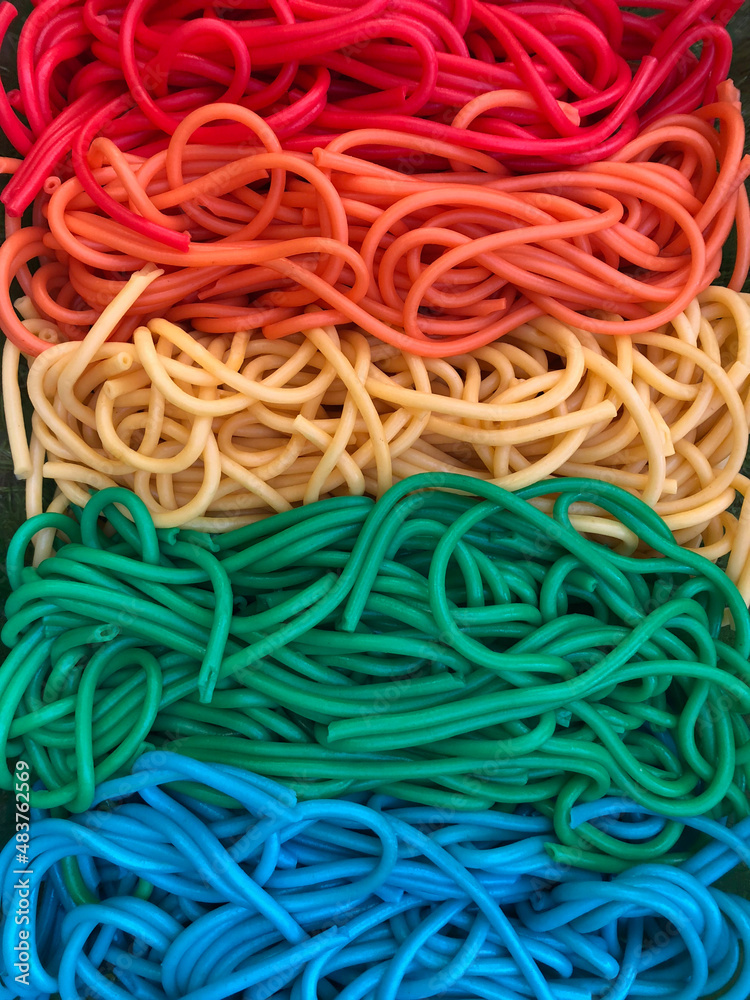 Vertical tray of Rainbow coloured spaghetti