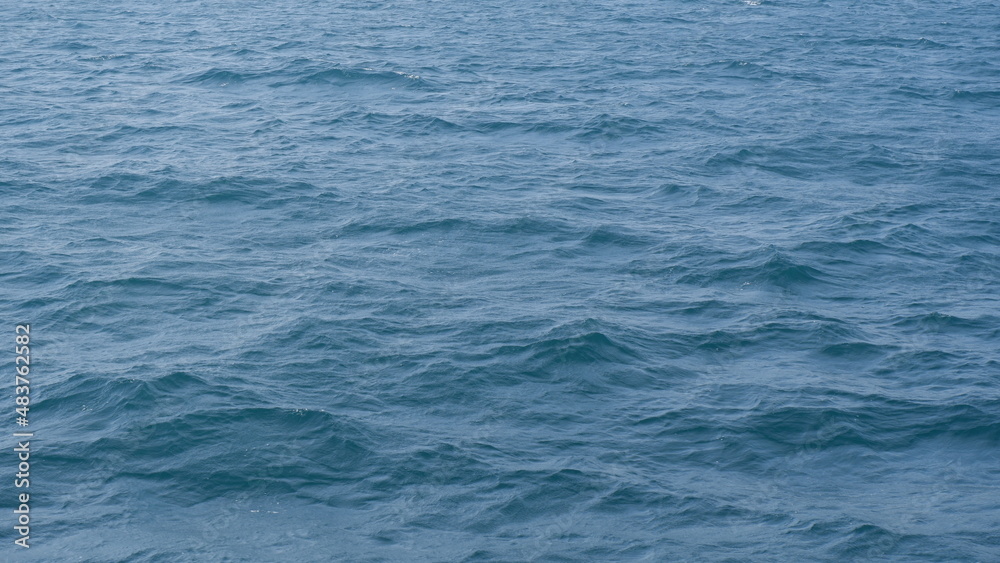 Full frame of dark blue sea surface with many waves