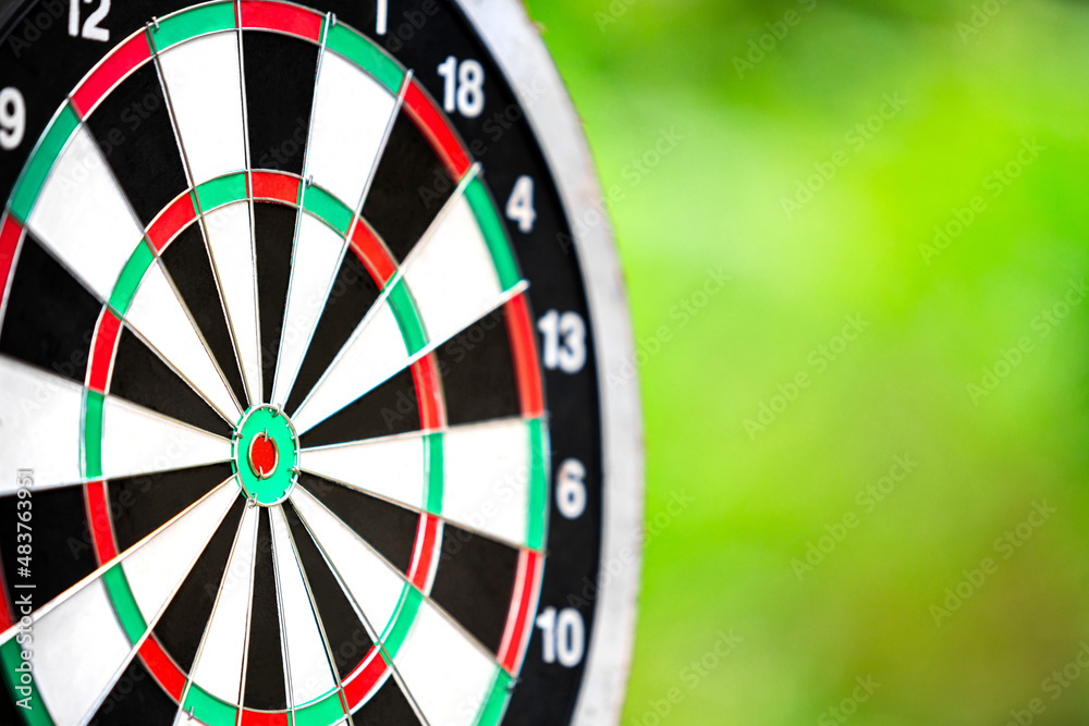 dartboard closeup with blur bokeh of forest background for objective business target, dart board sport and business concept dartboard closeup with blur bokeh of forest background for objective business target, dart board sport and business concept