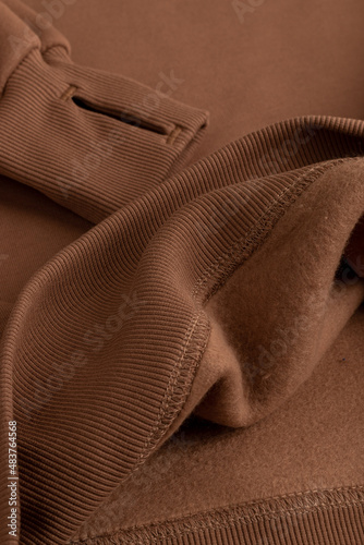 Hoodie texture. Close-up shot of sweatshirt hoodie brown textile warm fabric macro background.