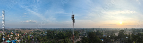 Telecommunication tower of 4G and 5G cellular. Macro Base Station. 5G radio network telecommunication equipment with radio modules and smart antennas mounted on a metal on cloulds sky background. photo