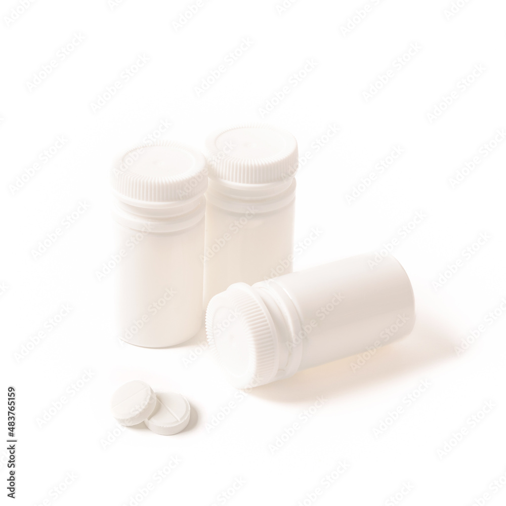 white medicine jars on a white isolated background.