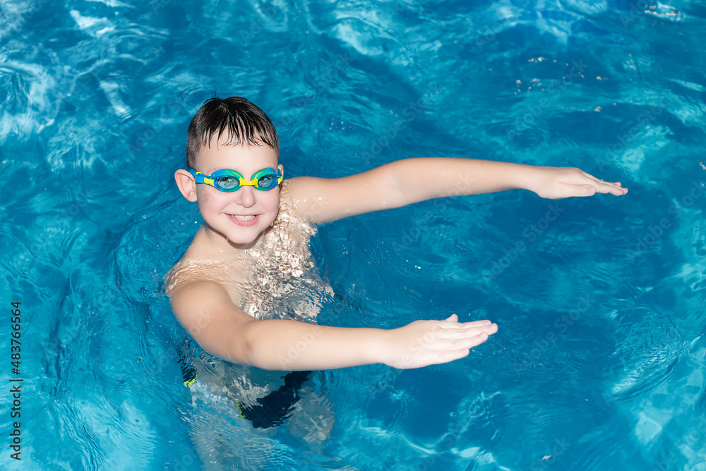 A happy smiling boy swims in the sea. Healthy lifestyle. Swimming. Sports and recreation