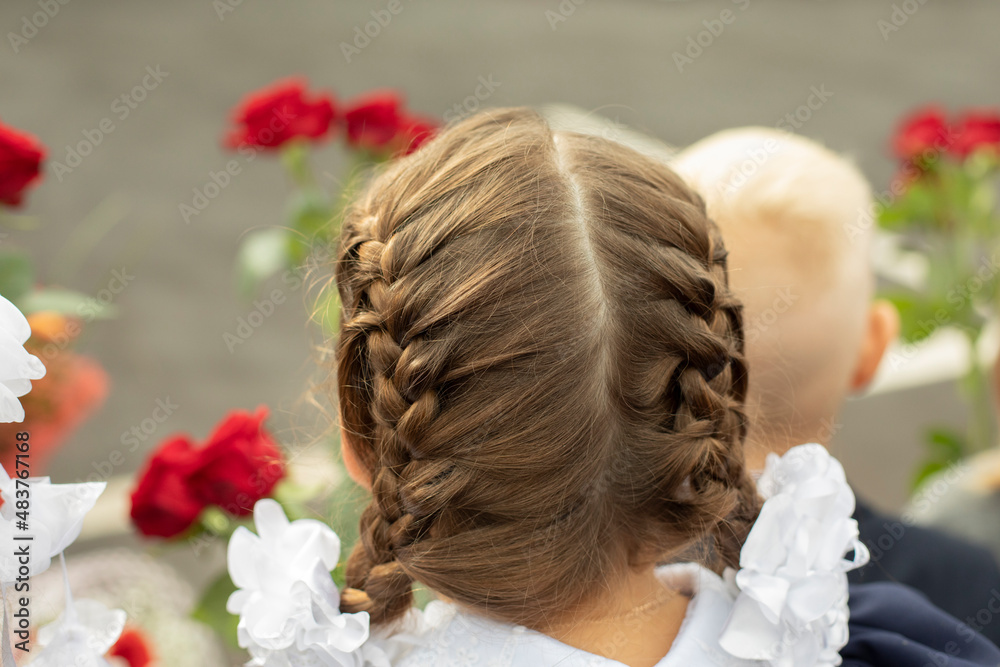 Naklejka premium Student with flowers. Schoolgirl at party at school. Girl in Russia on Day of Knowledge.