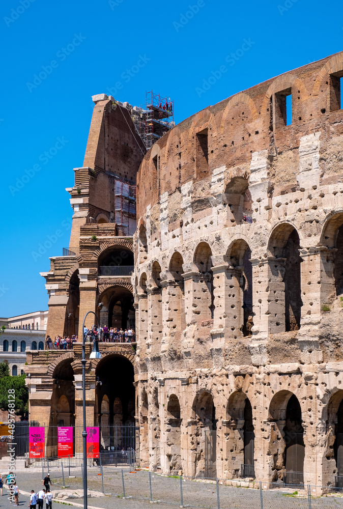 Colosseum ancient theater known as Flavian Amphitheatre aside Palatine Hill and Roman Forum Romanum in historic city center of Rome in Italy