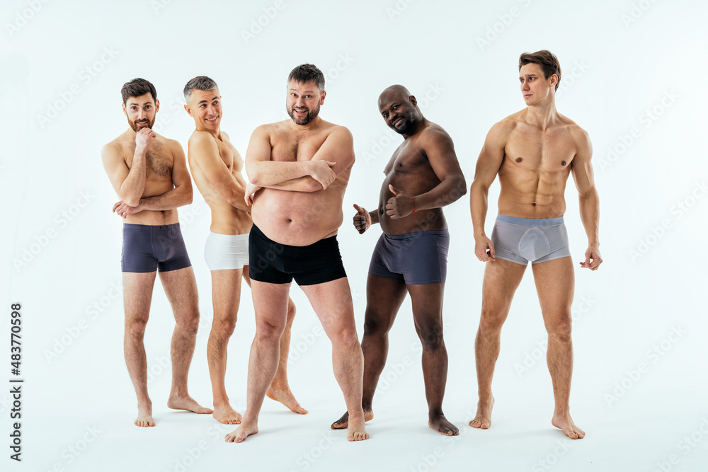 Group of multiethnic men posing for a male edition body positive beauty set. Shirtless guys with different age, and body wearing boxers underwear