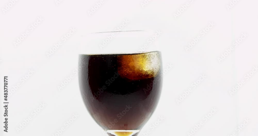Cool drinks and ice cube in isolated glass on a white background. Cool drinks and ice cube in isolated glass on a white background.