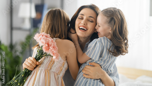 daughters are congratulating mother