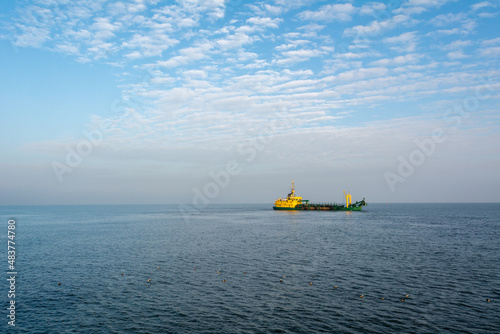 Hopper dredger ship is working to deepen the fairway on the sea. Baltic Sea, Poland © vivoo