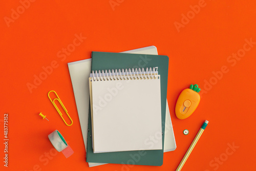 School stationery on red background. Top view with copy space. Flat lay. Back to school concept.