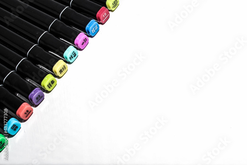 Set of colored markers. Color numbers on caps. Close-up. Isolation on a white background.