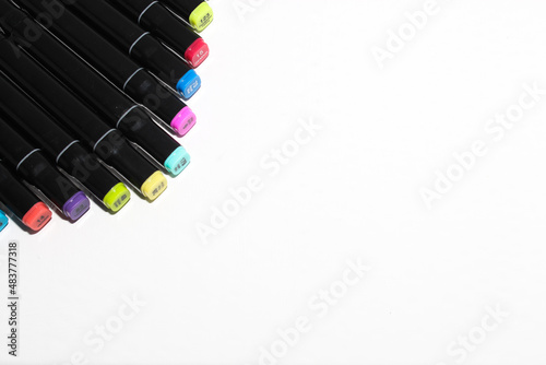 Set of colored markers. Color numbers on caps. Close-up. Isolation on a white background.