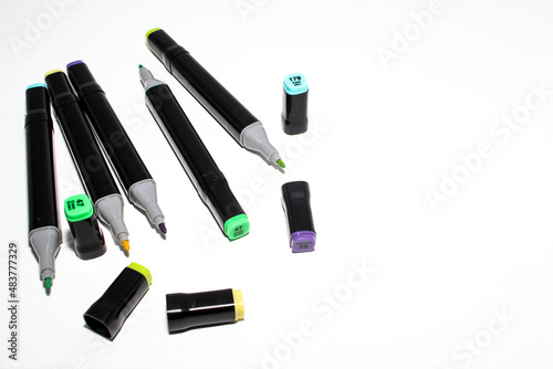 Set of colored markers. Color numbers on caps. Close-up. Isolation on a white background.