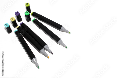 Set of colored markers. Color numbers on caps. Close-up. Isolation on a white background.