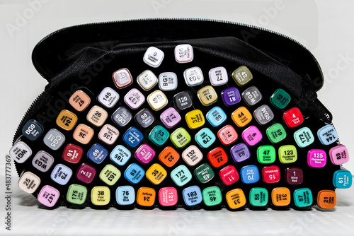 Set of colored markers. Color numbers on caps. Close-up.